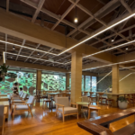 Modern interior of Nana Coffee Roasters in Bangkok featuring minimalist wooden decor, specialty coffee seating area, and trendy cafe ambiance