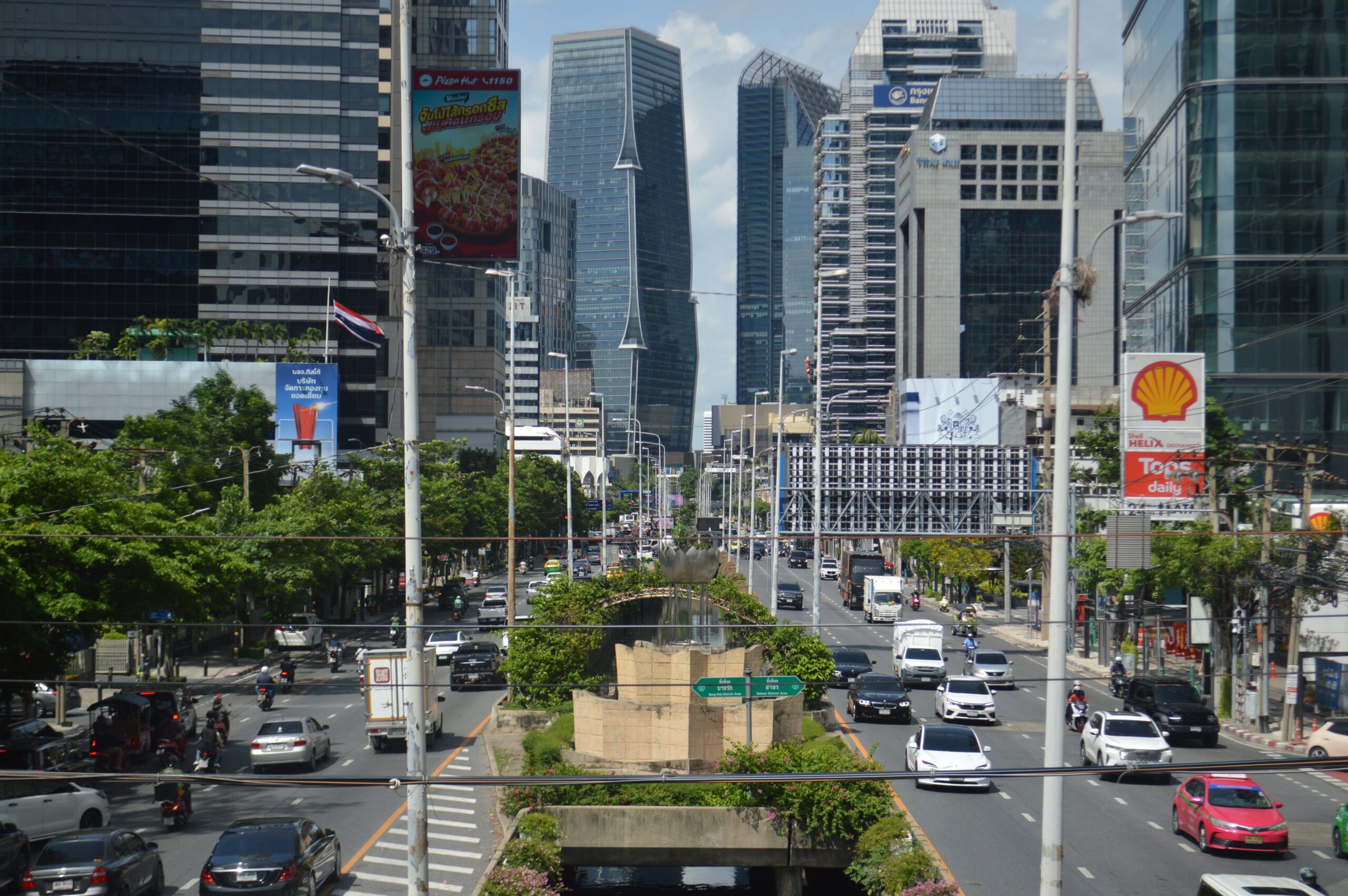 View of modern skyscrapers and heavy traffic in the Bangkok business district, a key consideration when planning your overall Bangkok travel cost