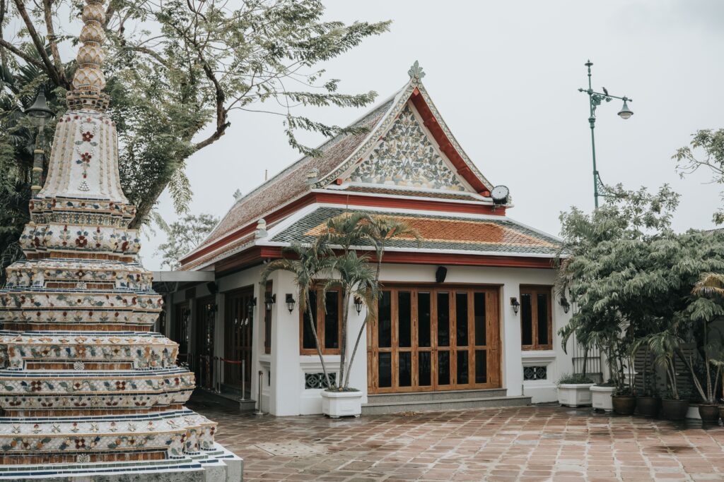 Intricate mosaic chedi and traditional Thai building at Wat Pho in Bangkok, the historic birthplace and school of traditional Thai massage.