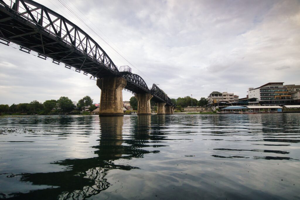 Historic Bridge on the River Kwai spanning the water in Kanchanaburi, a top historical day trip from Bangkok.